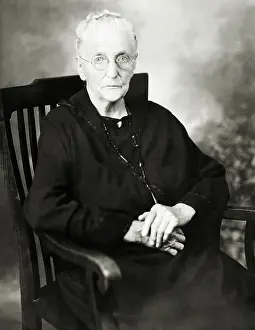 Studio Portrait Of Old Woman In Chair