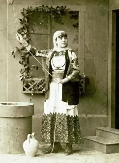 Britain Collection: Studio portrait of a woman in traditional Greek dress beside a fountain, 1869, Greece, Historical