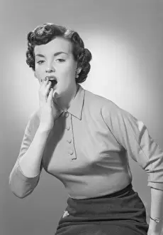 Studio portrait of woman yawning