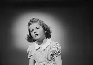 Impatient Prints: Studio shot of girl (6-7) grimacing