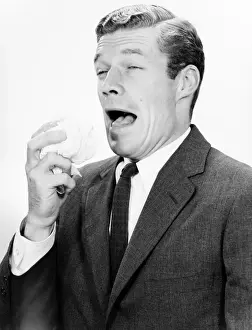 Handkerchief Prints: Studio shot of man sneezing