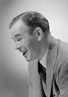 Exhilaration Prints: Studio shot of mid adult man laughing