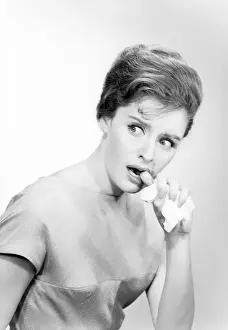 Biting Prints: Studio shot of young woman biting finger