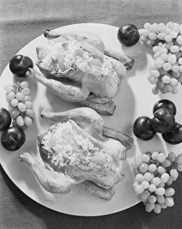 Stuffed chicken and fruits in plate, close-up