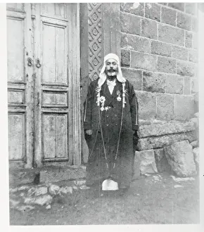 Sudanese Chief Posing in Front of Building