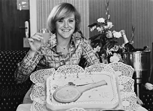 Prints of British tennis player Sue Barker raises a glass of champagne as she smiles behind her 21st birthday cake, which features a tennis racquet, April 1977. (Photo by Archive Photos/Getty Images) The Grand Slam Gallery: Sue Barker, British Tennis Player