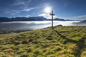 Misty Mood Prints: Summit cross of Gerenberg Mountain with high fog in front of the Alpstein Mountains