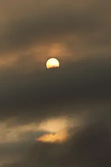 Awesome Prints: Sun behind clouds and brownish ash and gas clouds of the Holuhraun fissure eruption
