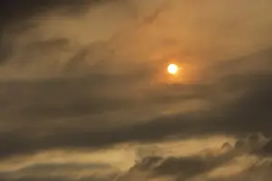 Sun behind clouds and brownish ash and gas clouds of the Holuhraun fissure eruption, north of the Baroarbunga volcano, highlands of Iceland, Northeastern Region, Iceland