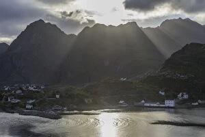 Sun rays breaking through the clouds over the mountains of the municipality of Moskenes, Lofoten, Nordland, Norway