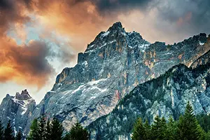 Prints of The afternoon sun setting in the Dolomite mountains of northern Italy. This peak stands majestically above the town of San Vito Di Cadore, Italy Travel Imagery Prints: The sun sets on a peak in the Dolomite mountains of Italy