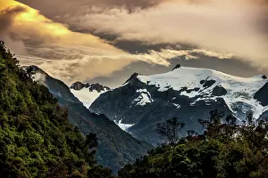 Prints of A serene sunset over the mountains and Franz Josef glacier, located in the center of the picture Travel Imagery Prints: The sun setting over the Franz Josef glacier located on the south island of New Zealand