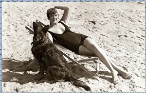Sunbathing Woman On Beach With Dog