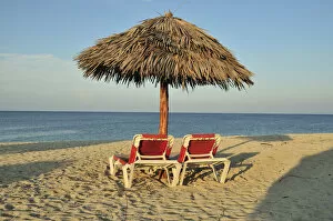 Sandy Beach Gallery: Empty sunbeds under a parasol on the beach of Playa Ancon near Trinidad, Cuba, Caribbean