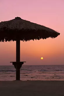 Images Dated 22nd October 2011: Sunrise with beach parasol, Dahab, Egypt, Africa