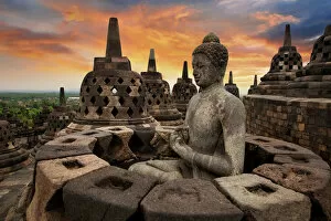 Buildings Collection: Sunrise with a Buddha Statue with the Hand Position of Dharmachakra Mudra in Borobudur, Magelang
