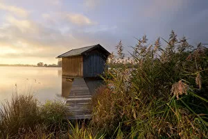 Images Dated 16th October 2011: Sunrise with a fishermans hut and a light morning mist near Rimsting on Lake Chiemsee, Bavaria