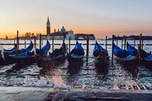 Sunrise view on gondola station near Piazza San Marco with Church of San Giorgio Maggiore on the backround during the rising tide