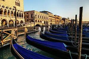 Town Square Prints: Sunrise view on gondola station near Piazza San Marco with Palazzo Ducale (Doges Palace) on a background