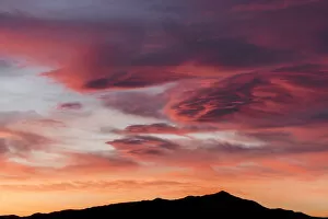 Images Dated 20th March 2016: Sunset lights up clouds above mountain ridge in Joshua Tree National Parks southern region