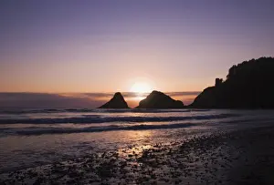 Sunset Behind Offshore Rocks Along The Oregon Coastline