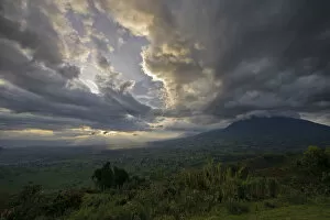 Sunset over the Virunga Mountains of the Volcanoes National Park in Rwanda with the rural settlements dotting