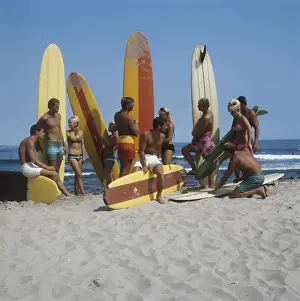 Blonde Hair Prints: Surfers holding surfboards on beach