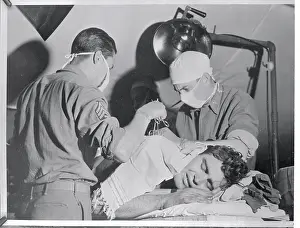 Surgeons Removing Shell Fragments From Patient