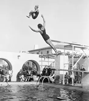 Swimmers Jumping Off the Diving Boards