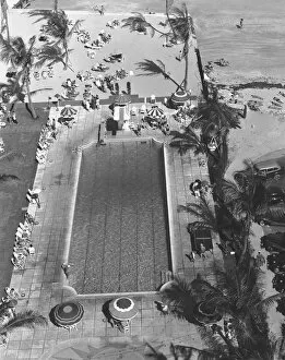 Swimming pool at seashore, (B&W), elevated view