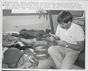 Swiss Soldier Looking over His Weapons at Home