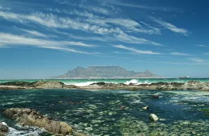 Table Mountain across the bay with rock pool in foreground