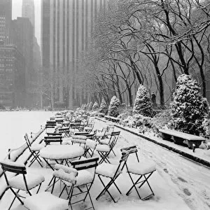Henri Silberman Collection Gallery: Tables and chairs in park covered with snow, New York City