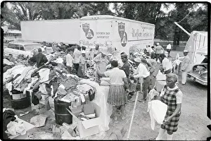 Distributing Prints: Tables Piled With Clothing