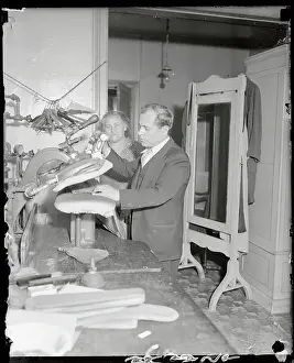 Tailor and Wife Pressing Clothes in Their Shop