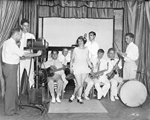 Prints of (Original Caption) 7/30/35-Philadelphia, Pennsylvania- In an effort to test the feasability of television in the home, a demonstration over a wire unit, and radio unit Timeless TV: A Visual Journey: Talent Show and Cameraman for Early TV Test