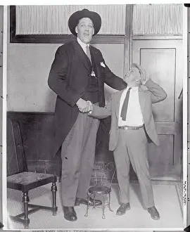 Tall Man Shaking Hand of Friend