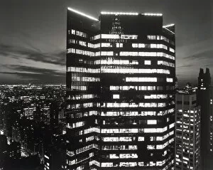 Tall office building with lights on at night