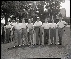 Team Lined Up with Golf Clubs on Course