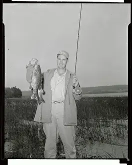 Ted Williams Holding up His Fish Catch