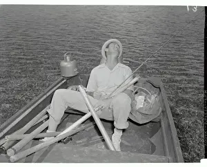 Ted Williams Sitting in Boat with Fishing Rod