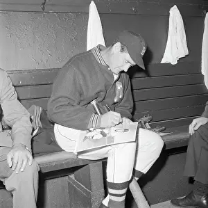 Ted Williams Sitting in Dugout and Signing for Fans