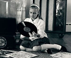 Retrofile Gallery: Teen girl with vinyl records and record player, sitting on floor