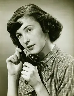 On The Phone Prints: Teenage girl (16-17) on phone posing in studio, (B&W), portrait