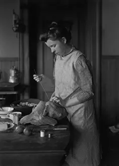 Sewing Prints: Teenage girl (16-17 years) stuffing turkey. August 06, 1925