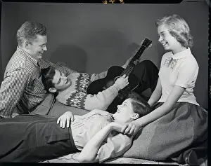 Teenagers Listening To Guitar