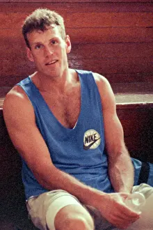 Prints of Professional NBA basketball player Dan Majerle of the Phoenix Suns rests between takes of a Nike 'Just Do It' television commercial wearing a blue Nike tank top sitting on the bleachers of Timeless Moments: A Visual Journey Through History’s Defining Images: Television Commercial
