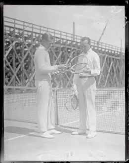 Tennis Players Checking Their Racquets