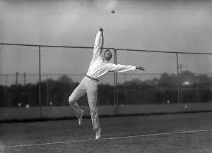 Prints of (Original Caption). June, 1919- Picture shows tennis pro Bill Tilden practicing his famous serve outside on a grass court A Game of Elegance: Tennis Through the Ages: Tennis Pro Bill Tilden Serving