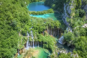 Prints of Aerial view of the terraced lakes in Plitvice Lakes National Park, a UNESCO World Heritage Site, in the mountainous karst area of central Croatia Capturing the Beauty of Landscapes, Travel, and Nature: Terraced lake with waterfalls, Plitvice Lakes National Park, Croatia